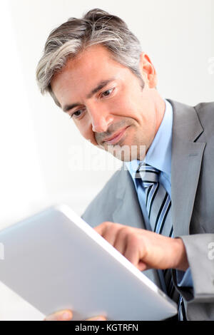 Portrait of businessman using electronic tablet Stock Photo