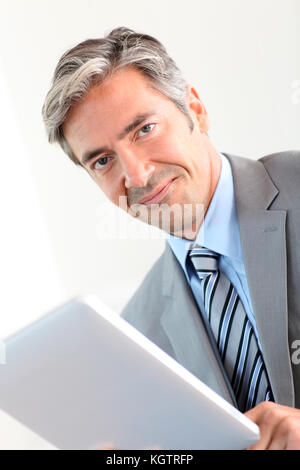 Portrait of businessman using electronic tablet Stock Photo