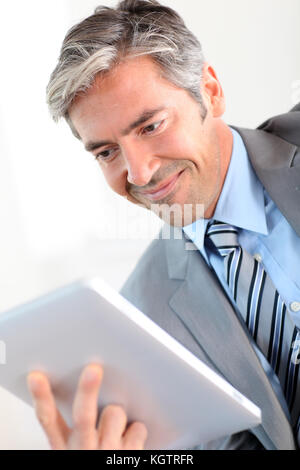 Portrait of businessman using electronic tablet Stock Photo