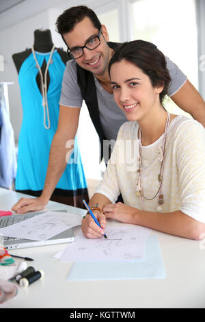 Fashion designers working on creation in workshop Stock Photo