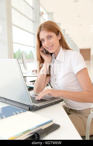 Smiling office worker in front of computer Stock Photo