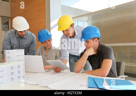 Educator with students in architecture working on electronic tablet Stock Photo