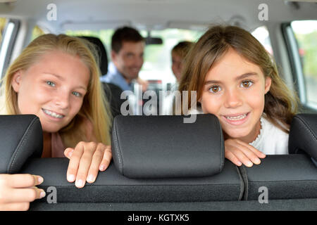 Portrait of young girls in car ready for car trip