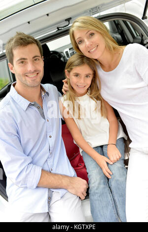 Family ready to leave for vacation with car