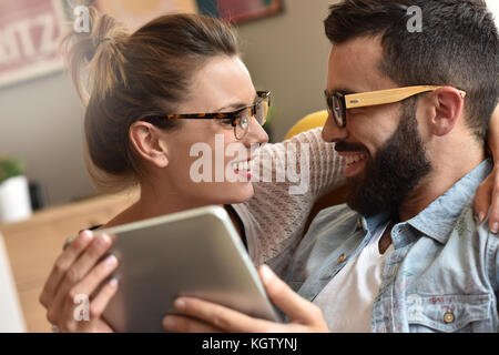 Hipster couple having fun using digital tablet Stock Photo