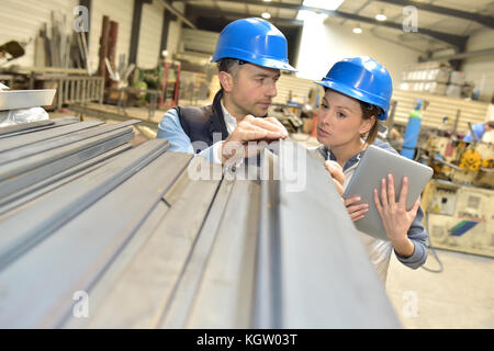 Supplier with engineer checking on production in factory Stock Photo