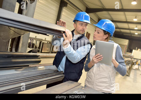 Supplier with engineer checking on production in factory Stock Photo