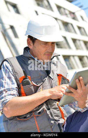 Entrepreneur on building site using tablet Stock Photo