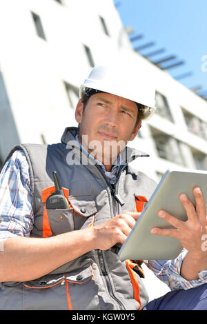 Entrepreneur on building site using tablet Stock Photo