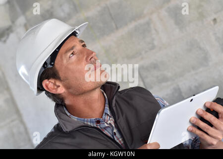 Construction manager using tablet on building site Stock Photo