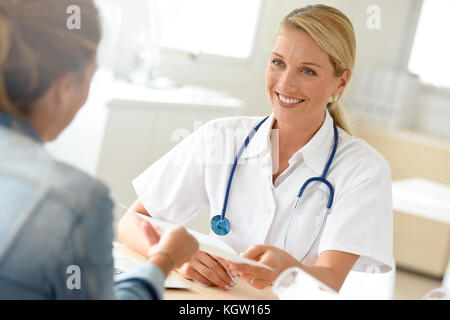 Portrait of doctor giving prescription to patient Stock Photo