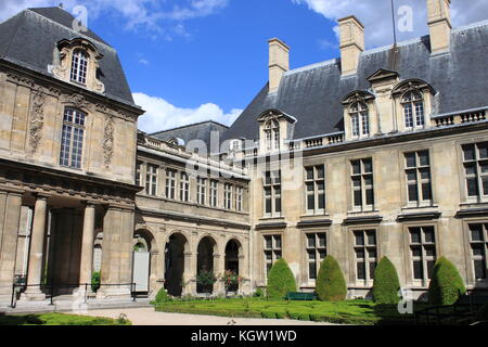 PARIS, FRANCE - MAY 24, 2015: Courtyard with the beautiful gardens of Carnavalet Museum. The museum was opened in 1880 and is dedicated to the history Stock Photo