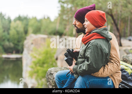 family with binoculars in forest Stock Photo