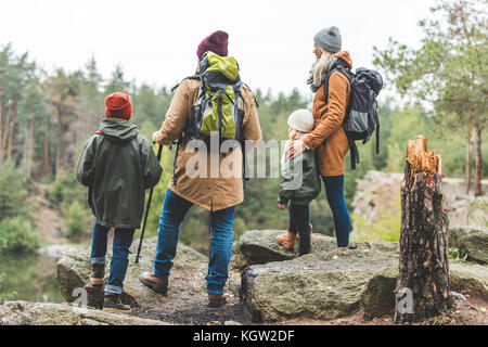 parents and kids trekking in forest Stock Photo