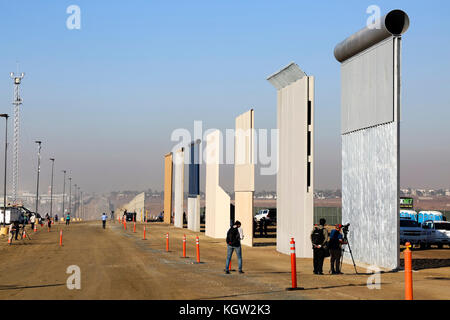 Trump administration new US-Mexico border wall prototypes are unveiled in October 2017. Eight different prototype sections of wall all 30 feet high (9 metres), the maximum height specified by the tender, and made of a mixture of concrete and metal are erected near the Otay Mesa Port of Entry in California. The designs will be subjected to testing to ensure they can withstand attack and attempts to go through, under and over them. See more information below. Stock Photo