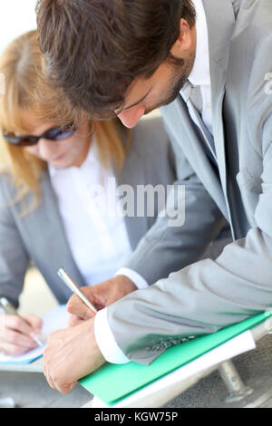 Business people signing contract Stock Photo