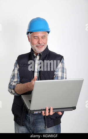 Construction worker using laptop computer Stock Photo