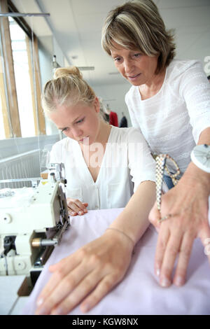 Student with teacher in dressmaking class Stock Photo