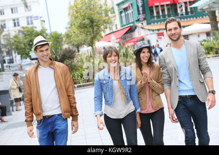 Group of friends walking in street and having fun Stock Photo