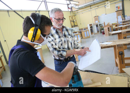 Carpenter with apprentice in training period Stock Photo