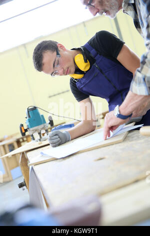 Carpenter with apprentice in training period Stock Photo