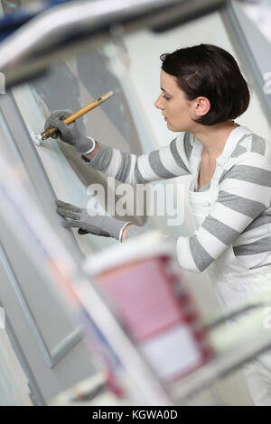 Young woman in professional school to become painter Stock Photo