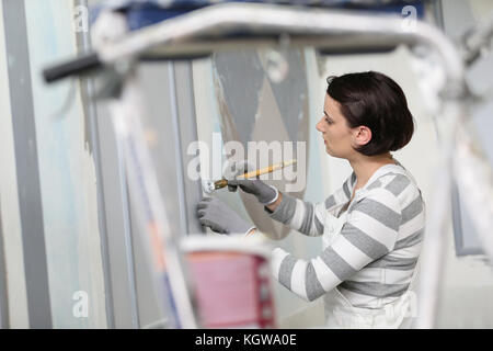 Young woman in professional school to become painter Stock Photo