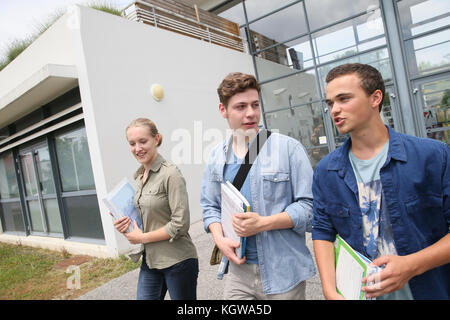 Young students walking outside campus building Stock Photo