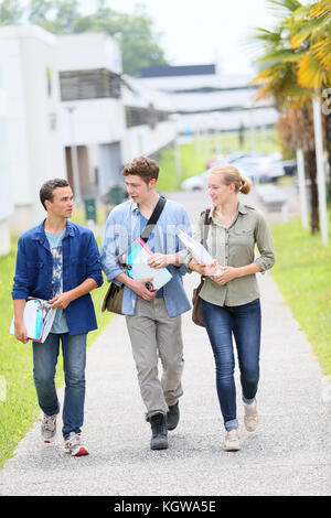 Young students walking outside campus building Stock Photo