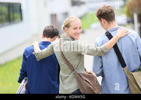 Young students walking outside campus building Stock Photo