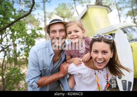 Couple with little girl enjoying vacation in camper van Stock Photo
