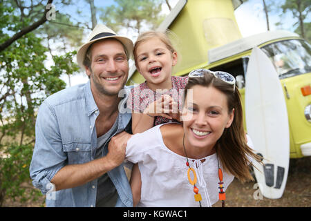 Couple with little girl enjoying vacation in camper van Stock Photo