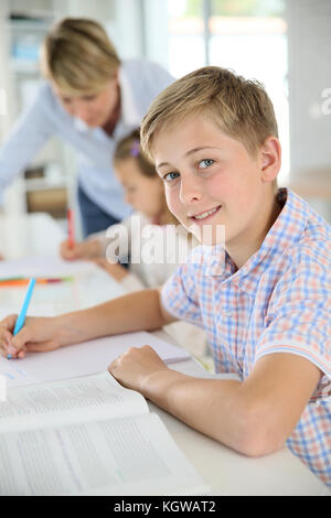 Young smiling schoolboy in classroom Stock Photo