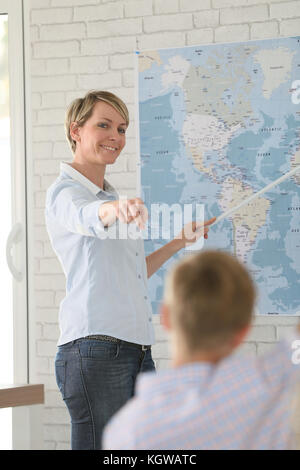 Teacher in classroom teaching geography to pupils Stock Photo