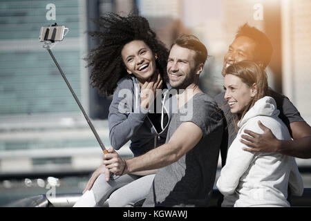 Group of friends taking selfie picture, Manhattan in background Stock Photo