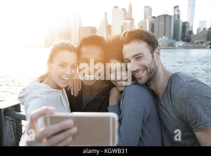 Friends taking selfie picture on Brooklyn heights promenade, NYC Stock Photo