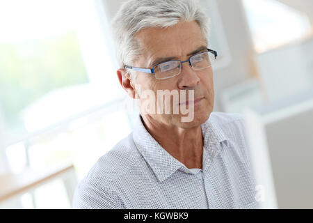 Senior man connected on desktop computer Stock Photo