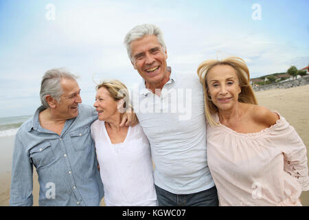 Senior people walking on the beach Stock Photo