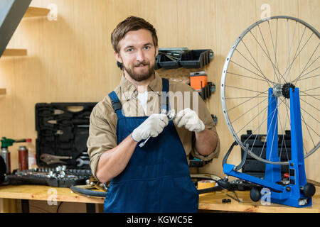 Successful specialist of repair looking at camera in his workshop Stock Photo