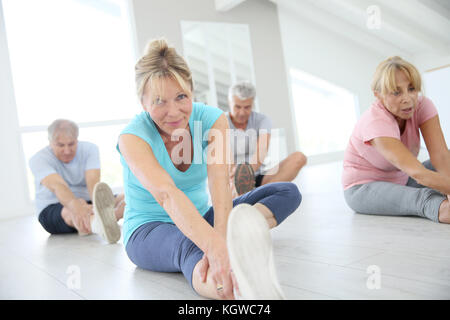 Group of senior people doing stretching exercises Stock Photo