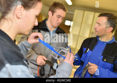 People in woodwork workshop putting security glasses on Stock Photo