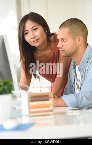 Business people in office working together on desktop Stock Photo