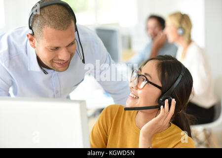Smiling customer office assistant with manager in office Stock Photo