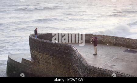 Man taking a photograph on the seafront at Brighton Stock Photo