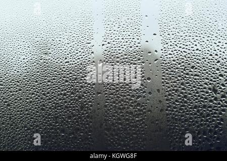 A view through dewy window with many small condensation drops. Stock Photo