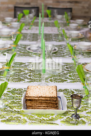 Matzo for Passover with Seder meal with wine on plate on table close up ...