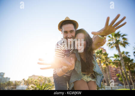 Portrait of happy man holding his girlfriend hands laughing Stock Photo