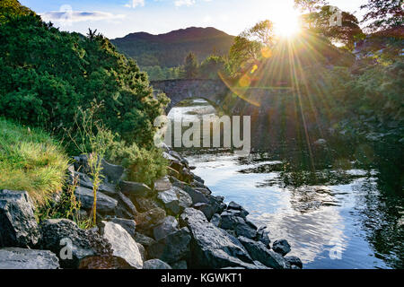Sunrise over old rock bridge in Gairloch on the Atlantic Coast of Scotland in Wester Ross Stock Photo