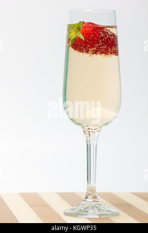 fresh strawberry on a glass filled sparkling wine Stock Photo