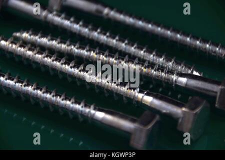 spanner or Hexagon head bolts with green Background and light reflections Stock Photo